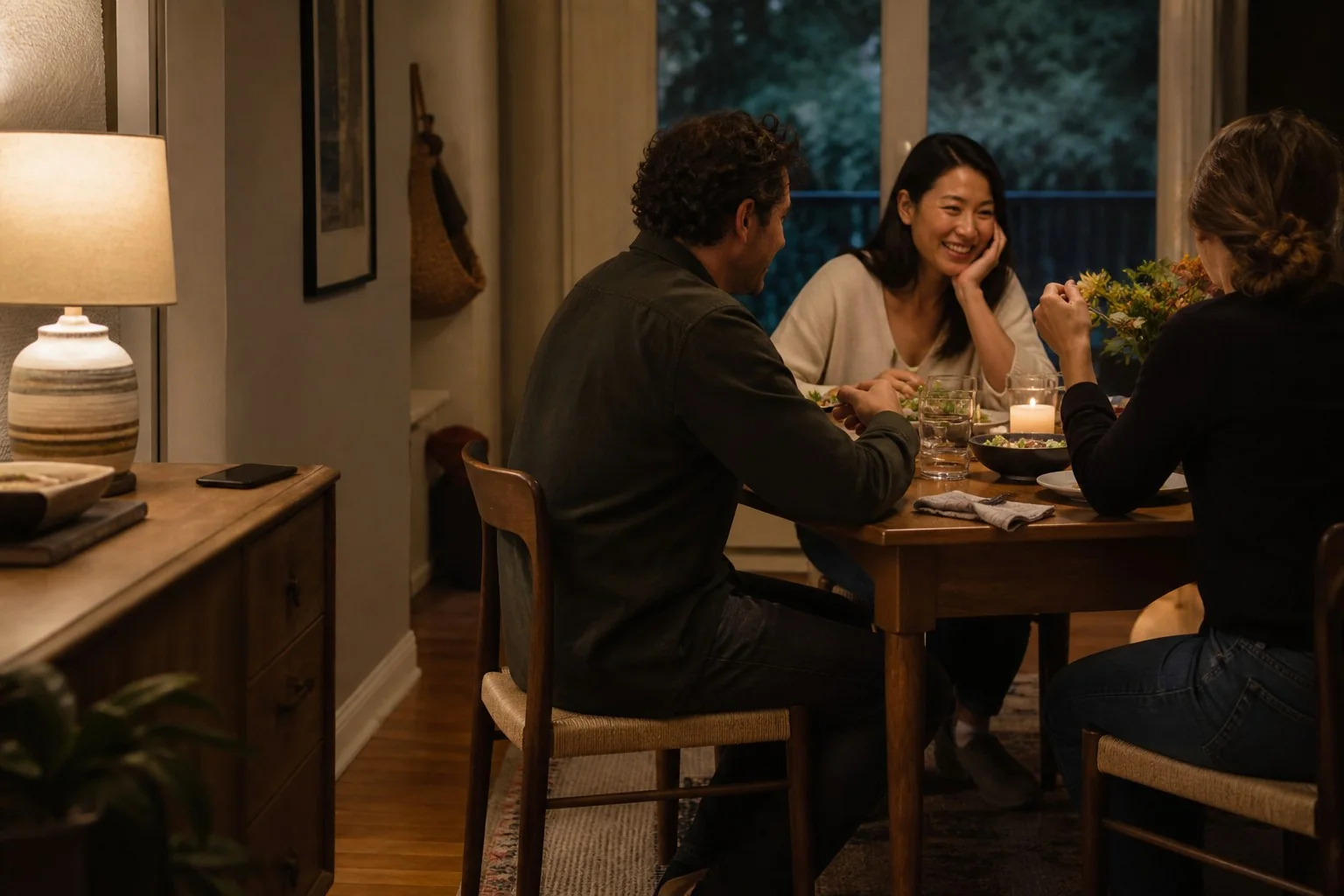 Friends sharing an easy meal while one phone stays away from the table.